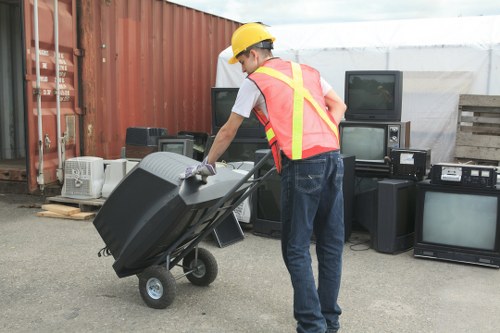 Workers measuring bulk waste for cubic-yard pricing